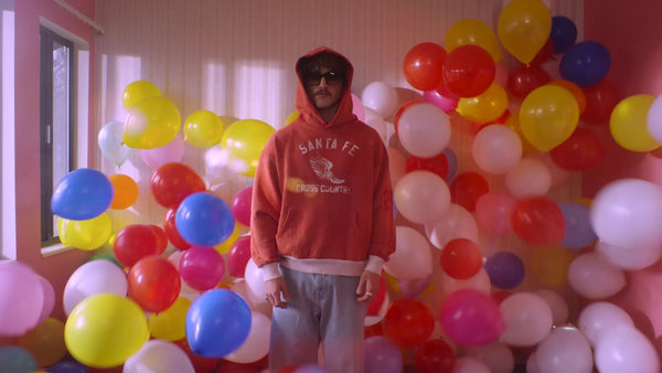 Benson Boone with many balloons around him.