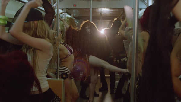 Chappell Roan in a subway with girls dancing around her.