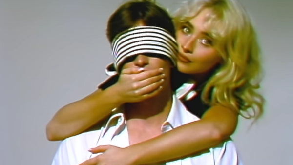 Sabrina Carpenter covering the mouth of a blindfolded man in the My Man on Willpowers video.