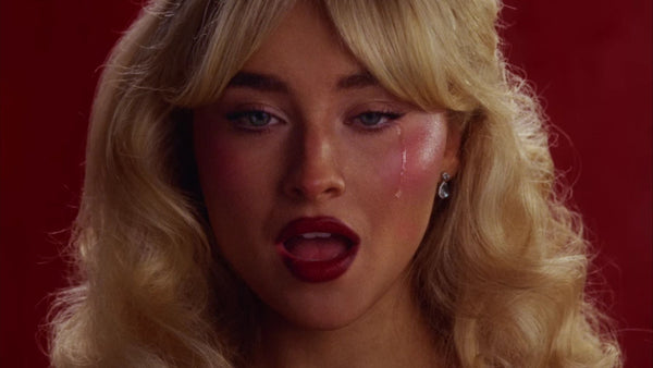 Sabrina Carpenter with a tear running down her cheek in the Tears music video.